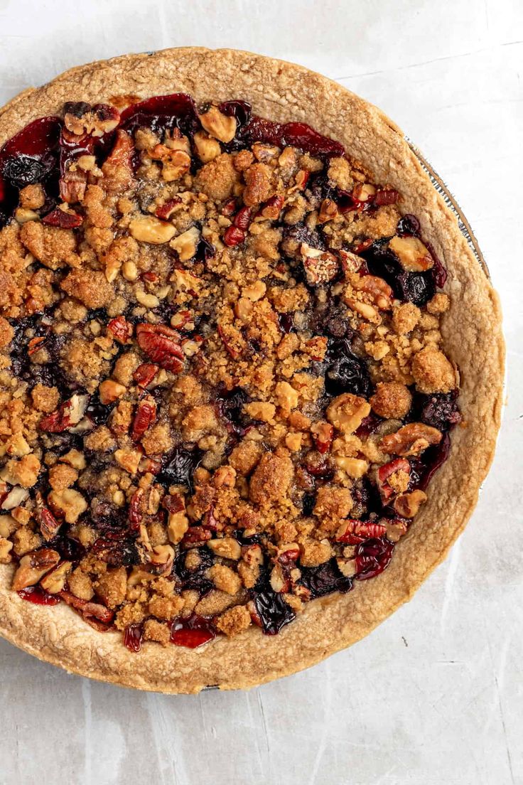 a pie with blueberries and crumbled toppings