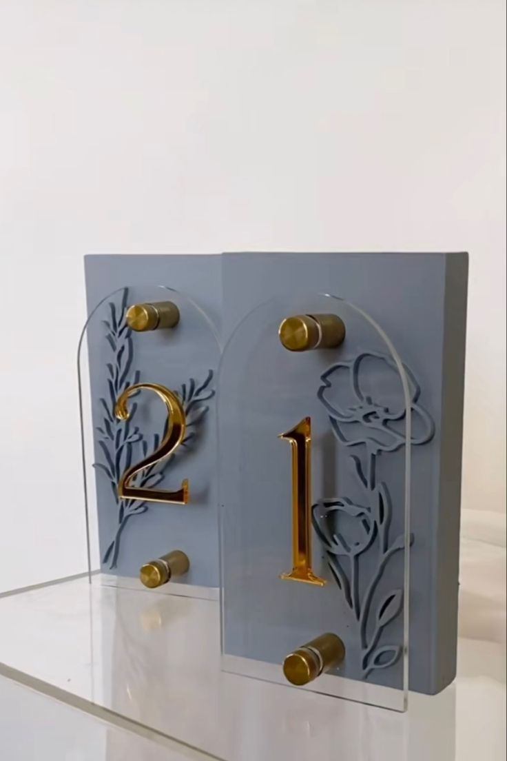 two greeting cards with gold numbers on them