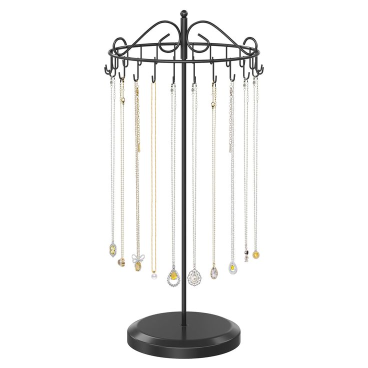 a jewelry stand with several necklaces hanging from it's hooks and chains on the top