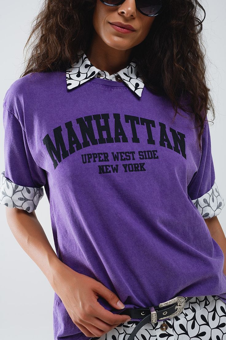 Introducing our Purple Relaxed T-Shirt With Manhattan Text– a statement piece that effortlessly combines comfort and style. Made in Italy, this oversized t-shirt features a relaxed fit and short sleeves, offering a laid-back yet chic look for everyday wear. The vintage black hue adds a touch of retro charm, while the graphic text proudly showcases "Manhattan Upper West Side New York."  This t-shirt, crafted with care in Italy, boasts a crew neckline for a classic touch. Its versatile design allows you to pair it effortlessly with jeans or skirts, creating a casual and stylish ensemble suitable for various occasions.  Made from 100% cotton, this t-shirt ensures a soft and comfortable feel against your skin, making it a go-to choice for all-day comfort. This shirt comes in size U, which mean Trendy Boxy Fit T-shirt With Text Print, Oversized Trendy Cropped T-shirt With Short Sleeves, Summer Drop Shoulder Top With Screen Print, Summer Screen Print Drop Shoulder Tops, Oversized Graphic Print Cropped T-shirt, Oversized Graphic Print Cropped T-shirt With Crew Neck, Oversized Graphic Cotton Cropped T-shirt, Oversized Graphic Tee For College, Oversized Spring College Style Top