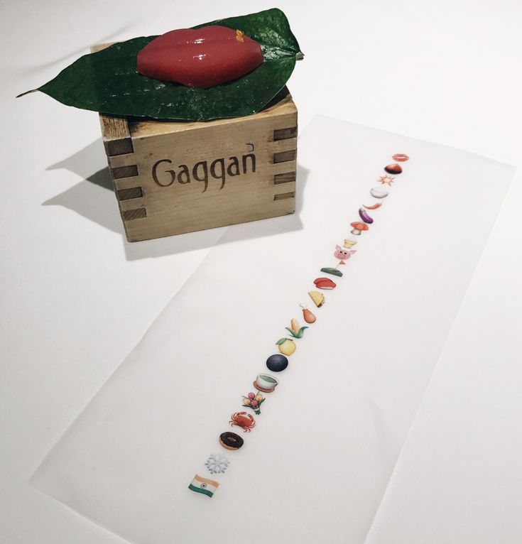 a wooden box filled with lots of different colored beads on top of a white table