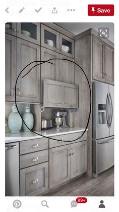 an instagramted photo of a kitchen with gray cabinets