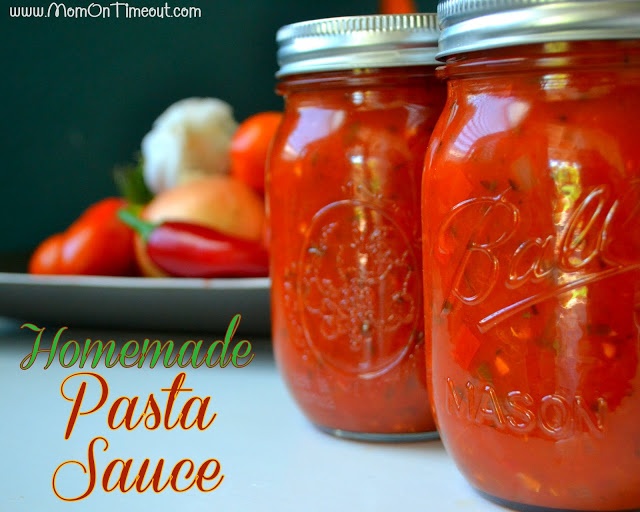 two jars filled with homemade pasta sauce sitting on a table next to tomatoes and peppers