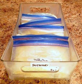 a plastic container filled with lots of blue and white striped papers on top of a counter