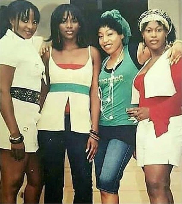 four women are posing for a photo together