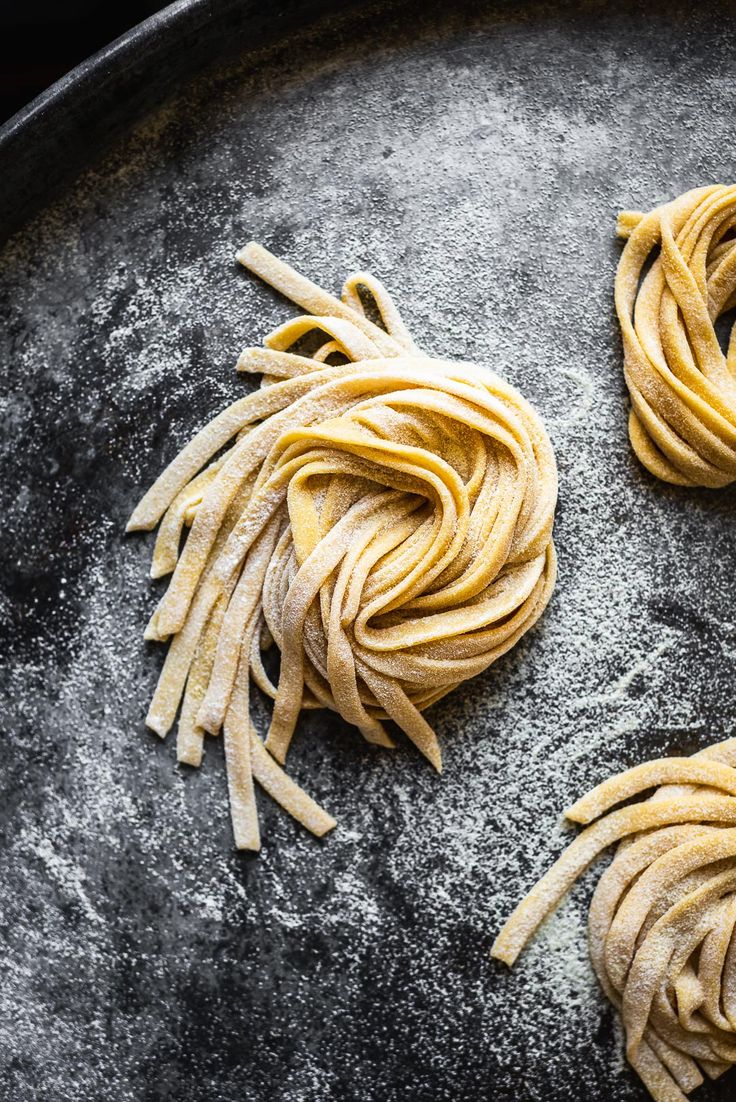 two uncooked pastas sit on a baking pan, one with noodle and the other without