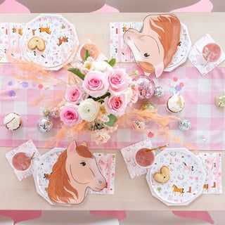 a table topped with pink flowers and plates