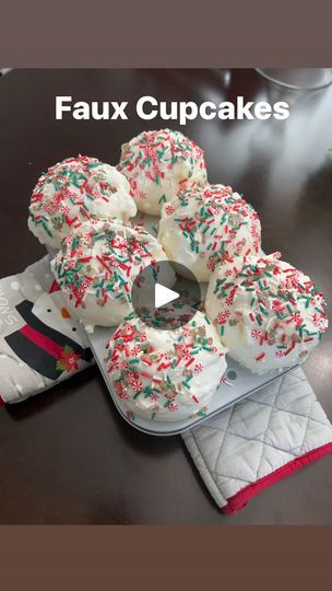 a bunch of doughnuts sitting on top of a table next to a pair of oven mitts