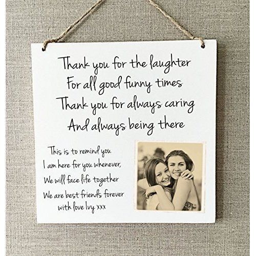 a white sign hanging on the wall with a message from two friends to each other