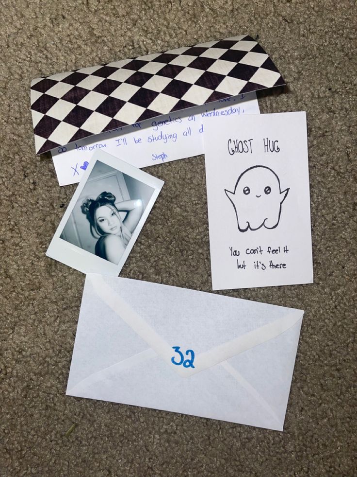 an envelope and some pictures on the ground