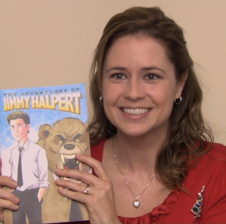 a woman holding up a copy of the adventures of jimmy halpert