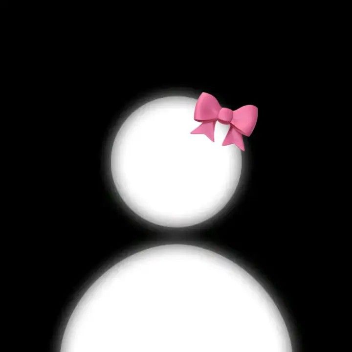 two snowmen with pink bows on their heads are shown in the dark night sky