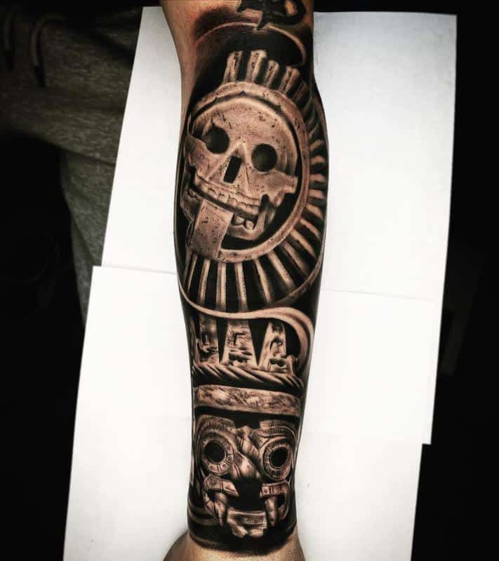 a man's leg with tattoos on it and an image of a skull in the middle