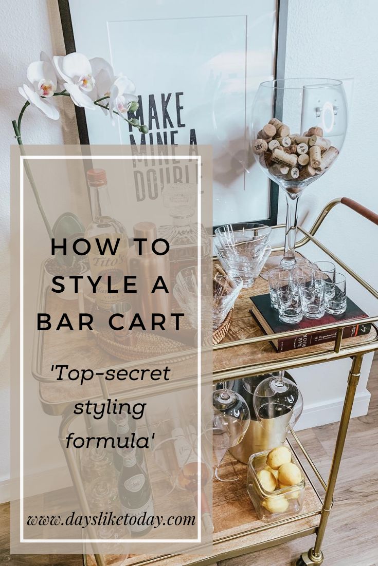 a bar cart with bottles and glasses on it in front of a framed poster that says how to style a bar cart top - secret styling formula