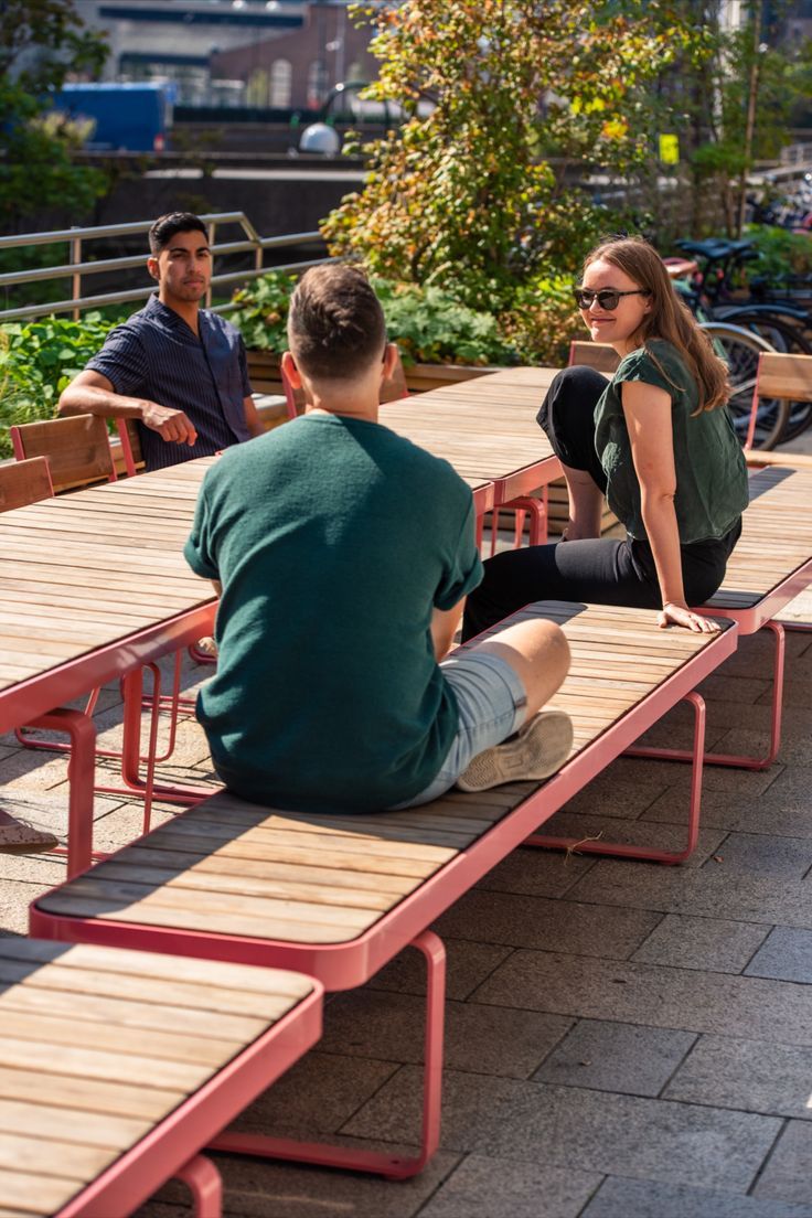 two people sitting on benches near each other