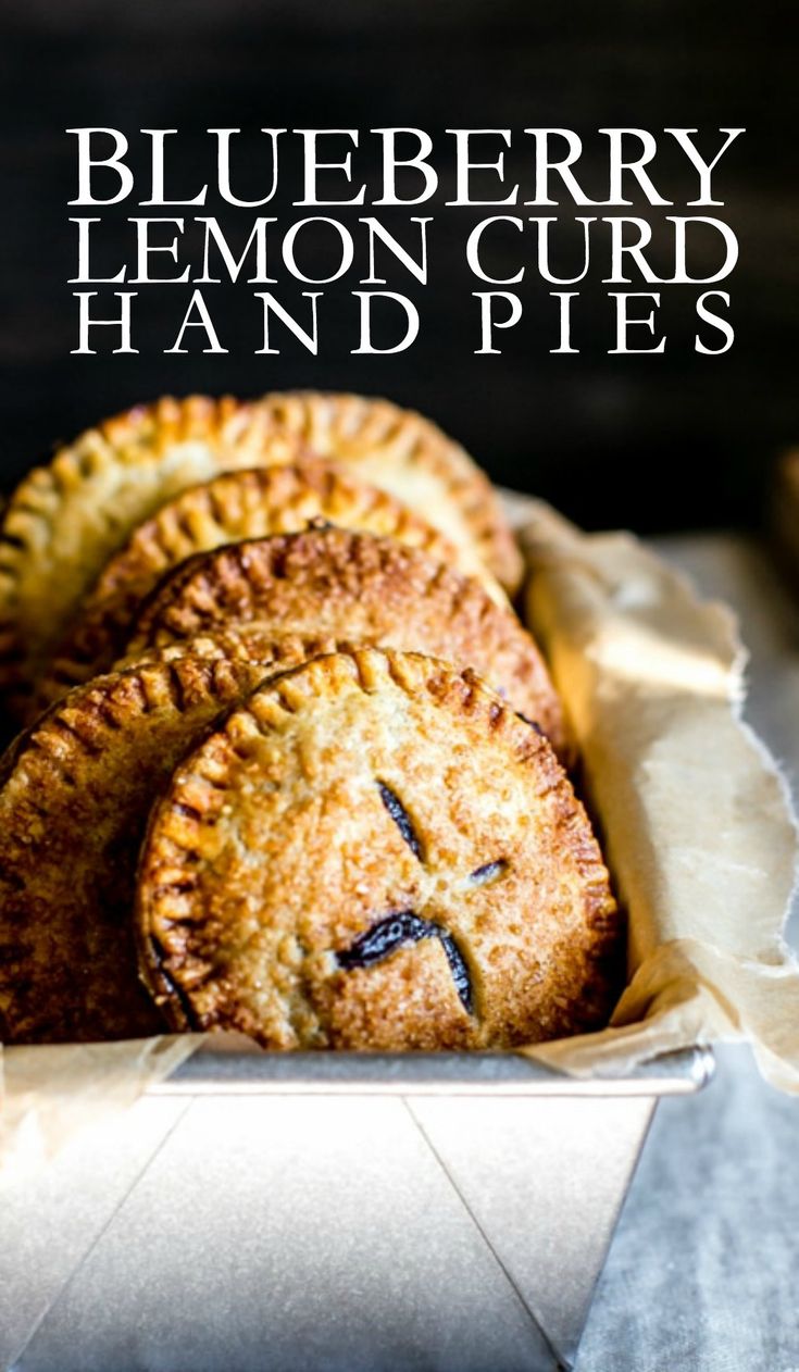 three blueberry lemon curd hand pies in a paper container with text overlay