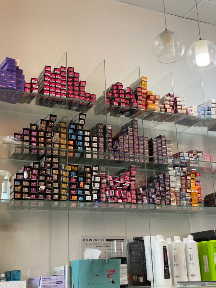 the shelves are filled with many different types of cosmetics and hair care products on display