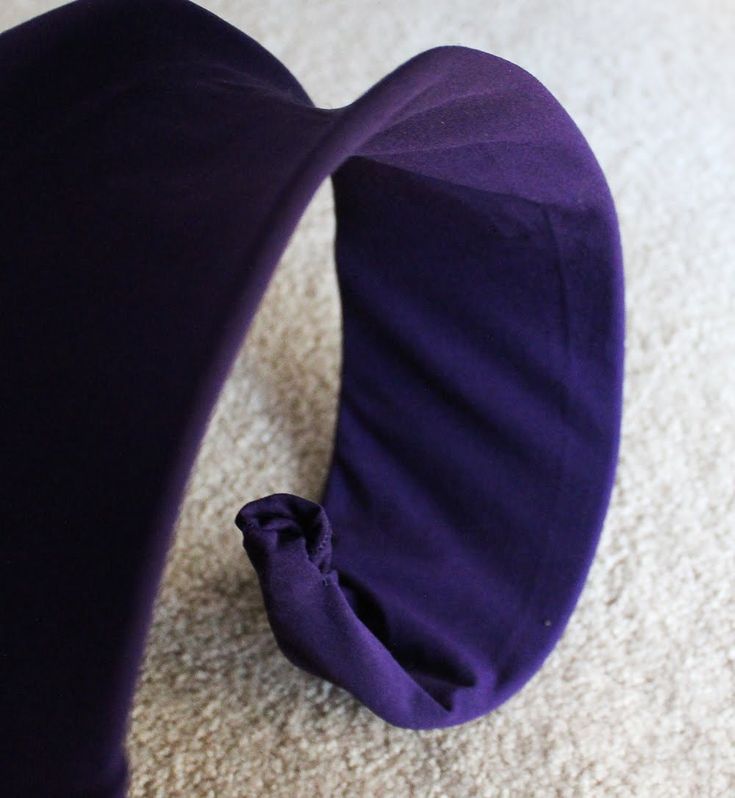 a purple pillow is laying on the floor