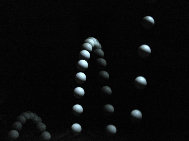 some white balls are floating in the dark