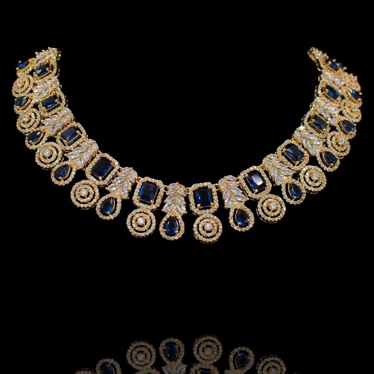 This wear-with-all piece is just perfect for those who love their statement accessories with mixed media flair! Timeless and modern, this hand crafted set dazzle with an elegant frame traced with CZ and sapphire stones. The set includes a necklace and a pair of matching earrings. Approximate earrings length is 1.5". Gold-plated on high-quality brass as base metal. Made by order. Kindly allow 5-7 weeks for the delivery of this item. For custom or urgent requests, please contact support@alacouture Sapphire Stones, Statement Accessories, Elegant Frame, A Necklace, Craft Set, Sapphire Stone, Rumi, Base Metal, Indian Jewelry