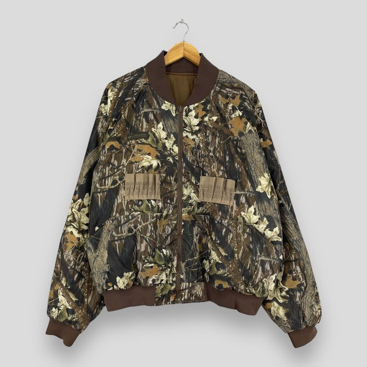 "REMINDER: THIS IS USED CLOTHING PLEASE DO NOT EXPECTED IT LIKE TO BE NEW OR IN PRISTINE CONDITION Feel free to contact me for any question. I'll assist you with my pleasure. Vintage 90's COLUMBIA Bomber Jacket Xlarge Columbia Usa Sportswear Camouflage Mossy Oak Tree Pattern Columbia Reversible Jacket Size XL *All measurements are taken with the garment flat on the ground. SIZE ON TAG :- None but fits like Size XL ACTUAL SIZE MEASUREMENT :- ARM PIT TO ARM PIT :- 28\" inches BACK COLLAR TO HEM :- 27\" inches CONDITION :- GREAT USED CONDITION. NO HOLES AND STAINS. ** WE ARE USING DHL EXPRESS, IT TAKES 3-5 WORKING DAYS ONLY TO ARRIVE. PLEASE LEAVE YOUR PHONE NUMBER ON THE NOTE WHILE MAKE A PURCHASE** REF : (11-10-2023) R99" Oversized Camouflage Winter Outerwear, Winter Camouflage Oversized Outerwear, Oversized Camouflage Outerwear For Winter, Casual Hunting Windbreaker For Fall, Fall Camouflage Outerwear For Hiking, Casual Fall Windbreaker For Hunting, My Pleasure, Reversible Jacket, Tree Pattern