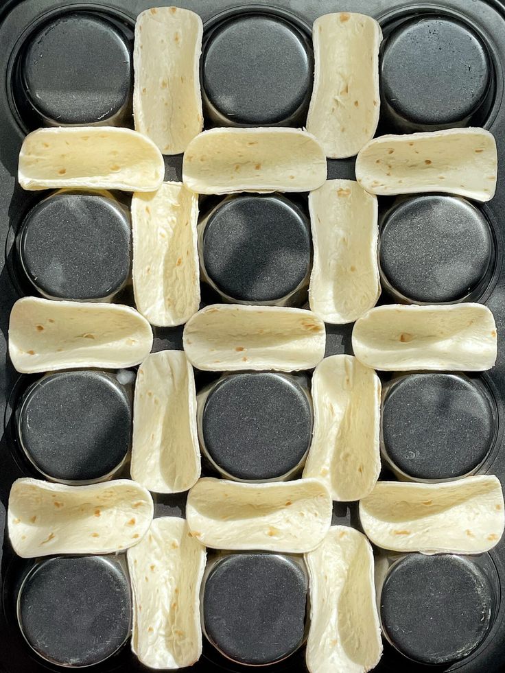 an uncooked pan filled with tortilla shells