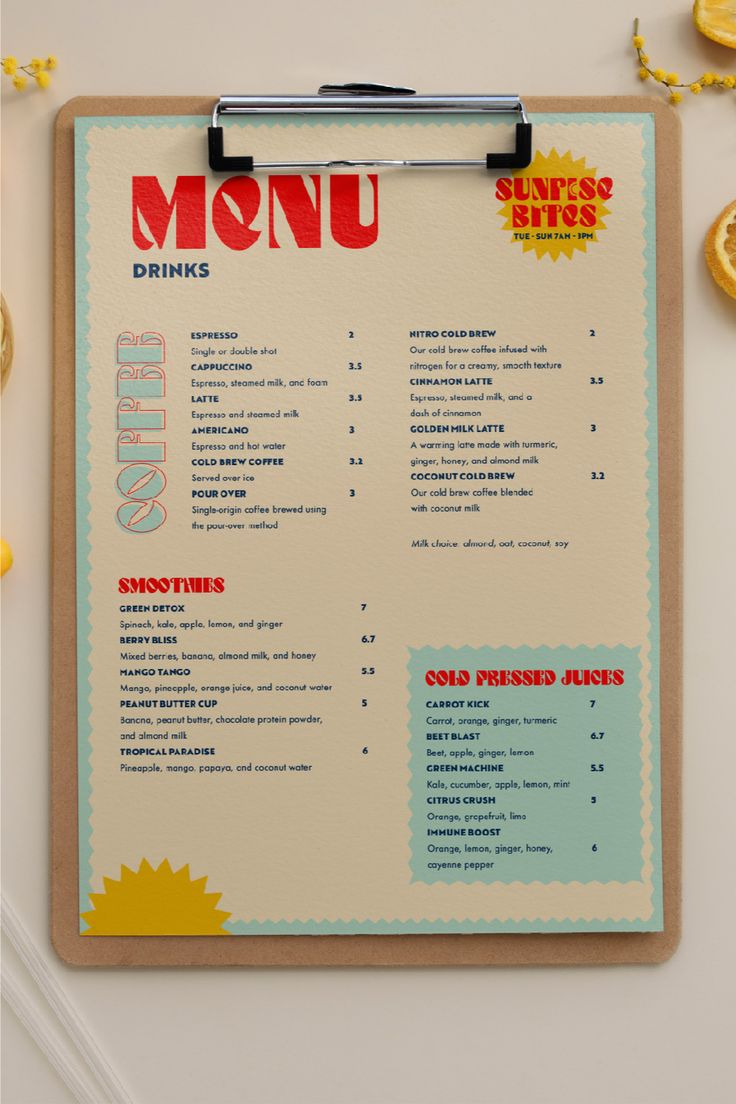 a menu on a clipboard next to some lemons and other food items in front of it