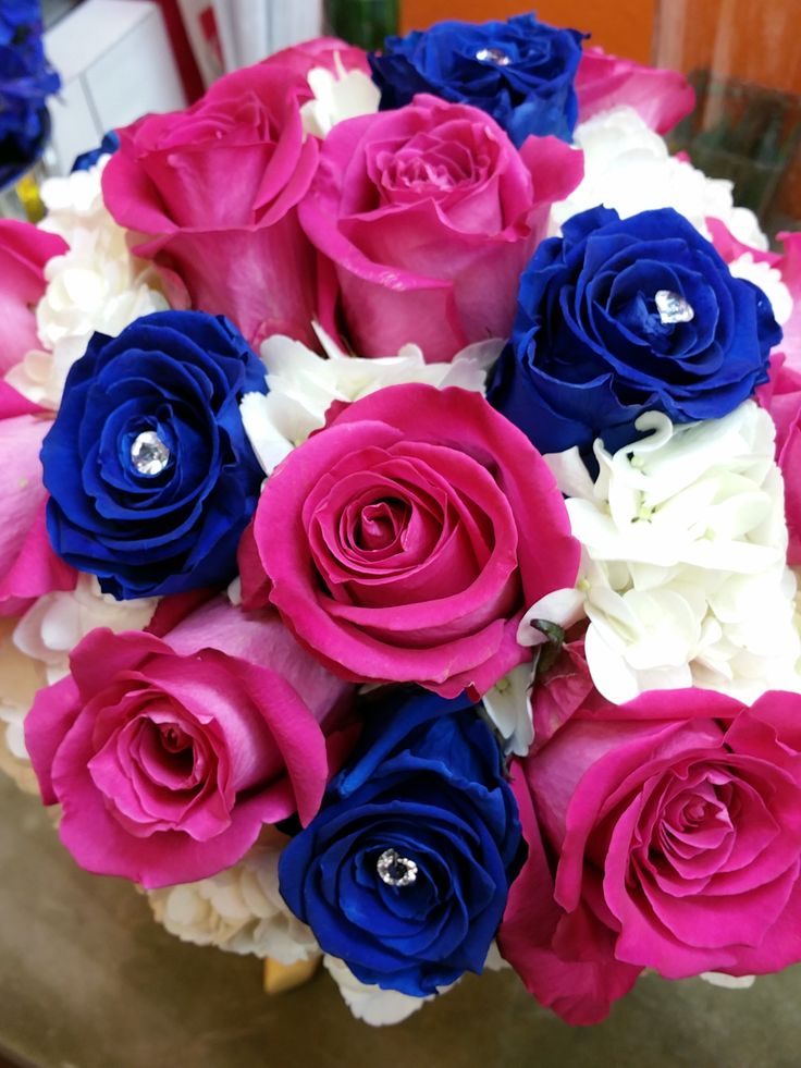 a bouquet of pink, blue and white flowers