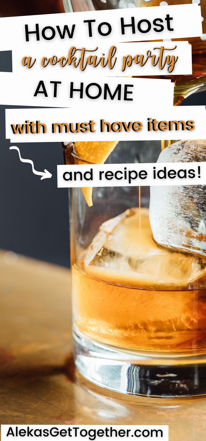 a glass filled with ice sitting on top of a table next to an orange slice