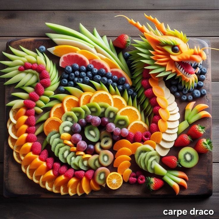 a dragon made out of fruits and vegetables on a cutting board