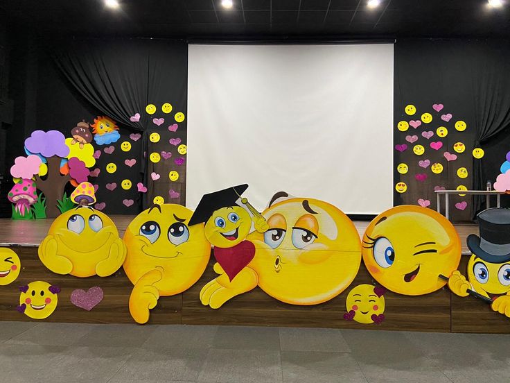 a group of yellow emoticions sitting on top of a stage