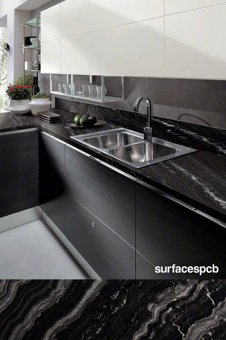 a black and white kitchen with marble counter tops