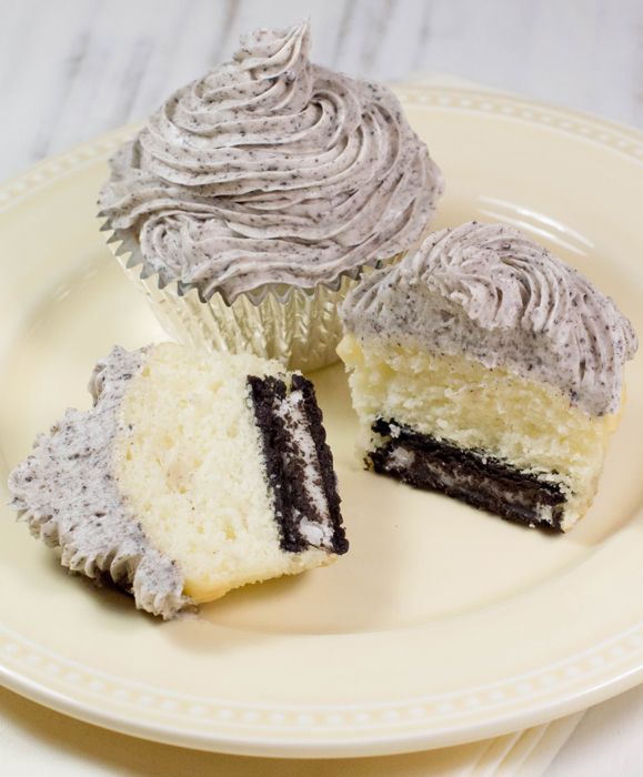 two cupcakes on a plate with the words cookies and cream cupcakes