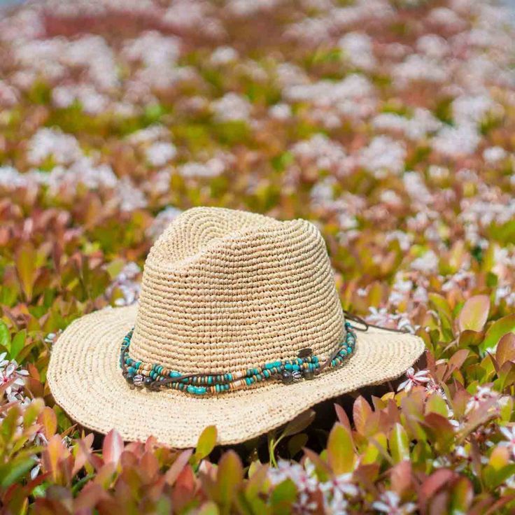 The Kooringal Bora Bora straw fedora hat is a great, easy wearing hat. Made of durable crochet raffia, it can pack and crush very easily making it a great travel companion and a style you shouldn't have to worry too much about. The base of the crown is decorated with a double line of multi-color beads and an additional black string that can be used to make minor size adjustments. The inside is unlined, but has a comfortable elasticized sweatband to aid in sizing. Brim 2 1/2" Crown Pinched Crown Bohemian Beige Straw Hat For Travel, Country Style Straw Hat With Woven Detail, Bohemian Wide Brim Lightweight Straw Hat, Bohemian Straw Hat For Travel And Vacation, Bohemian Adjustable Lightweight Straw Hat, Straw Hats For Beach Season Travel, Casual Braided Festival Hat, Casual Braided Hat For Festivals, Casual Braided Straw Hat For Festival