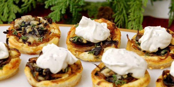 small appetizers with cream on them are sitting on a plate