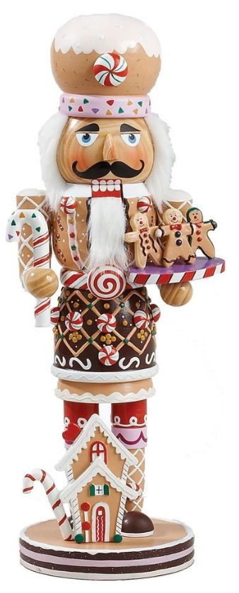 a christmas nutcracker with candy canes and cookies on his chest, standing in front of a white background