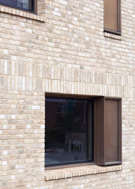 an image of a brick building that has windows on it and the words dezeen are