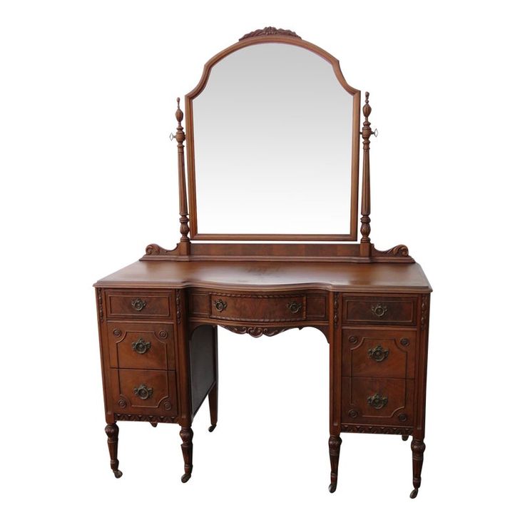 an antique dressing table with mirror and drawers