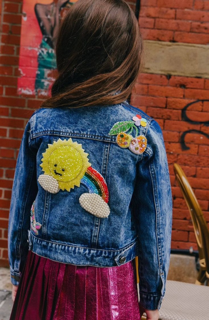 Description: Trendy denim jacket adorned with cheerful crystal embellishments, including a smiling sun, a rainbow, and fruity accents for a playful and unique look. Features a classic button-down front, chest pockets, and a cropped fit for versatile styling. Perfect for layering over casual outfits to add a touch of sparkle and personality. Material & Care: Made from durable denim with intricate crystal embellishments for added flair. Spot clean or hand wash cold to protect embellishments; lay f Multicolor Denim Outerwear With Patches, Cute Medium Wash Cotton Denim Jacket, Multicolor Denim Jacket With Patches For Spring, Multicolor Patched Denim Jacket For Spring, Spring Denim Jacket With Patches In Dark Wash, Cute Medium Wash Denim Jacket, Trendy Denim Outerwear With Embroidered Patch, Cute Medium Wash Cotton Outerwear, Cute Medium Wash Outerwear For Spring