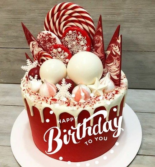 a red and white cake sitting on top of a plate covered in candy canes