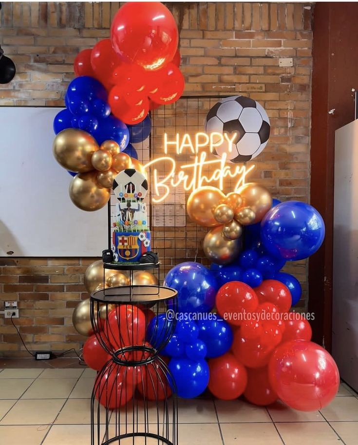 a birthday party with balloons and soccer balls