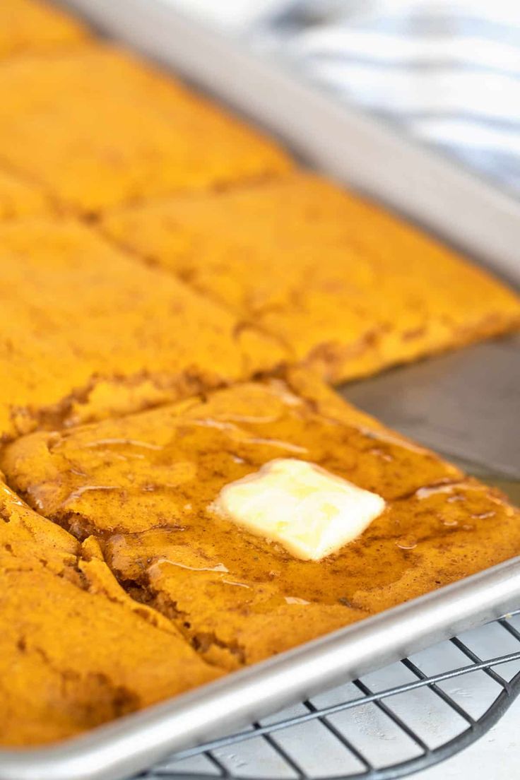 a pan filled with baked goods on top of a cooling rack and covered in icing