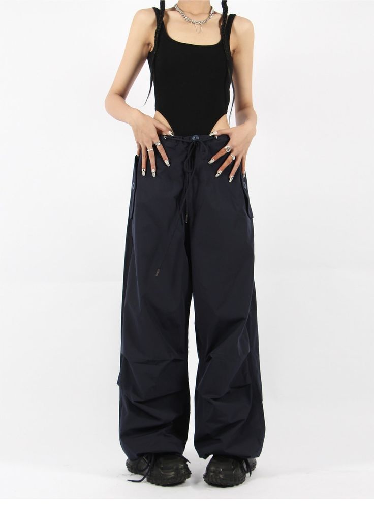 There’s a new trend in town, and it’s nightcity clothing’s Button Pocket Oversized Parachute Pants. These comfy, lightweight pants look great when paired with a crop top or graphic tee and sneakers. With a drawstring waistline, these pants are comfortable and secure, and the oversized fit gives them an effortless and chill look. Add these pants to your wardrobe, and you’ll never have a dull moment — you’ll always be ready for an impromptu night out, no matter how casual it might be.
Gender: Wome Casual Parachute Pants For Night Out In Spring, Urban Wide Leg Loungewear Bottoms, Versatile High Waist Parachute Pants With Relaxed Fit, Casual Cargo Pants With Pockets For Night Out, High Waist Parachute Pants For Summer Streetwear, Casual Cargo Pants For Night Out, Versatile Wide Leg Parachute Pants, Casual Relaxed Fit Bottoms For Night Out, Casual Spring Parachute Pants For Night Out