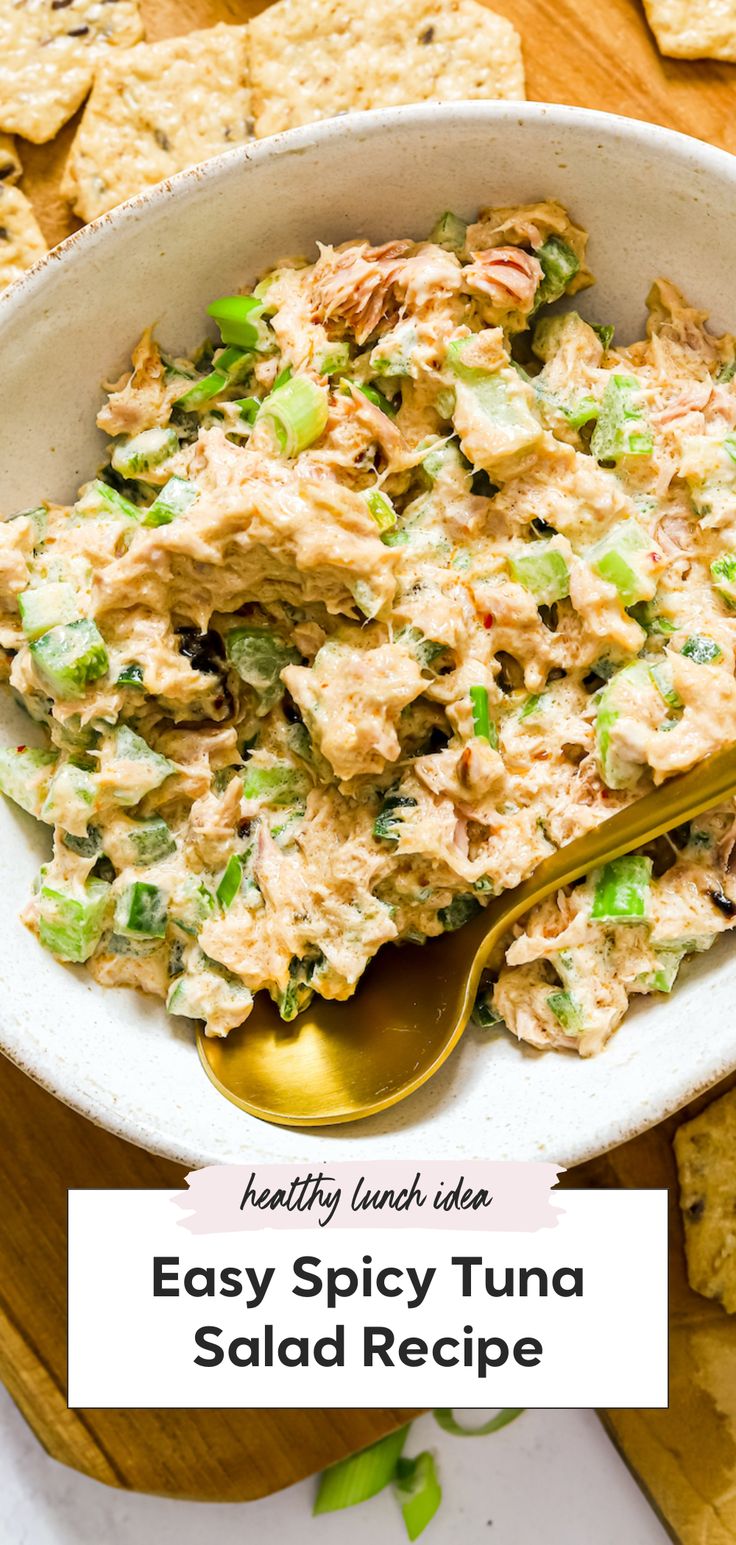 easy spicy tuna salad recipe in a white bowl with a gold spoon and tortilla chips on the side