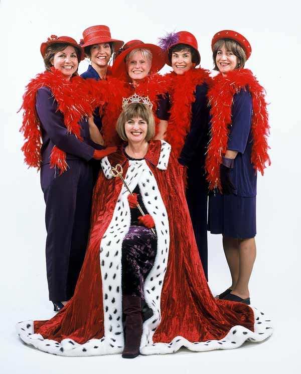 a group of women dressed in costume posing for a photo