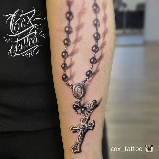 a woman with a rosary tattoo on her arm