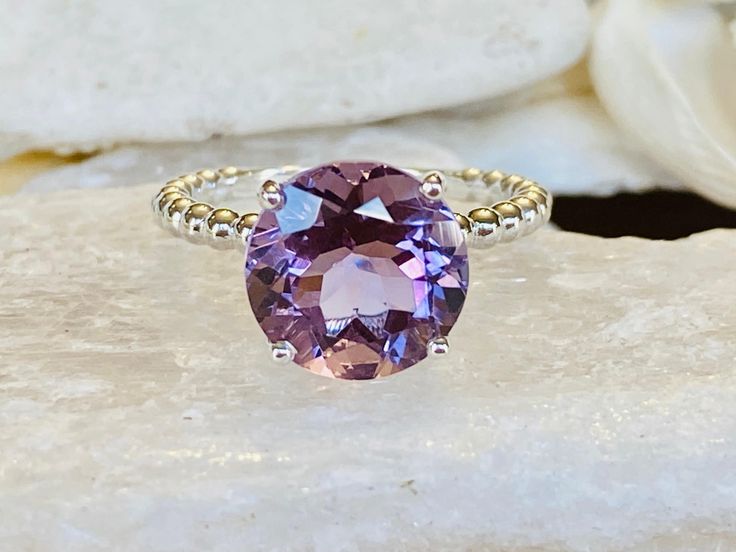 This beautiful solitaire setting contains a natural 3.8ct round Rose De France amethyst. The stone measures approximately 10mm. The band is 2mm wide and features beautiful beaded detailing. The ring is available in sterling silver, and 14k white, yellow, or rose gold. This ring makes a unique promise or engagement ring. Please send me a message if you need a size not listed. * This ring can be customized with any color center stone. All items are handmade by me in my shop in Woodbridge, NJ. Plea Luxury Round Crystal Ring With Amethyst, White Gold Amethyst Ring With Gemstone Accents, Round Amethyst Gemstones With Accents, Amethyst Ring With Gemstone Accents, Round Amethyst Ring With Gemstone Accents For Anniversary, Sterling Silver Amethyst Ring With Gemstone Accents, Anniversary Amethyst Ring With Gemstone Accents, Amethyst Gemstone With Center Stone, Round Amethyst Ring With Center Stone