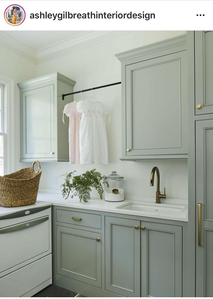 a kitchen with gray cabinets and white appliances