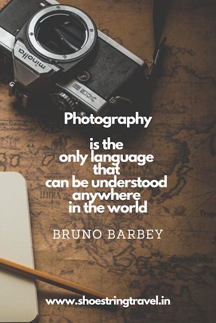 an old camera, notebook and pen on a map with the caption photography is the language that can be understand anywhere in the world