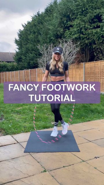 a woman standing on top of a yoga mat holding a sign that says fancy footwork